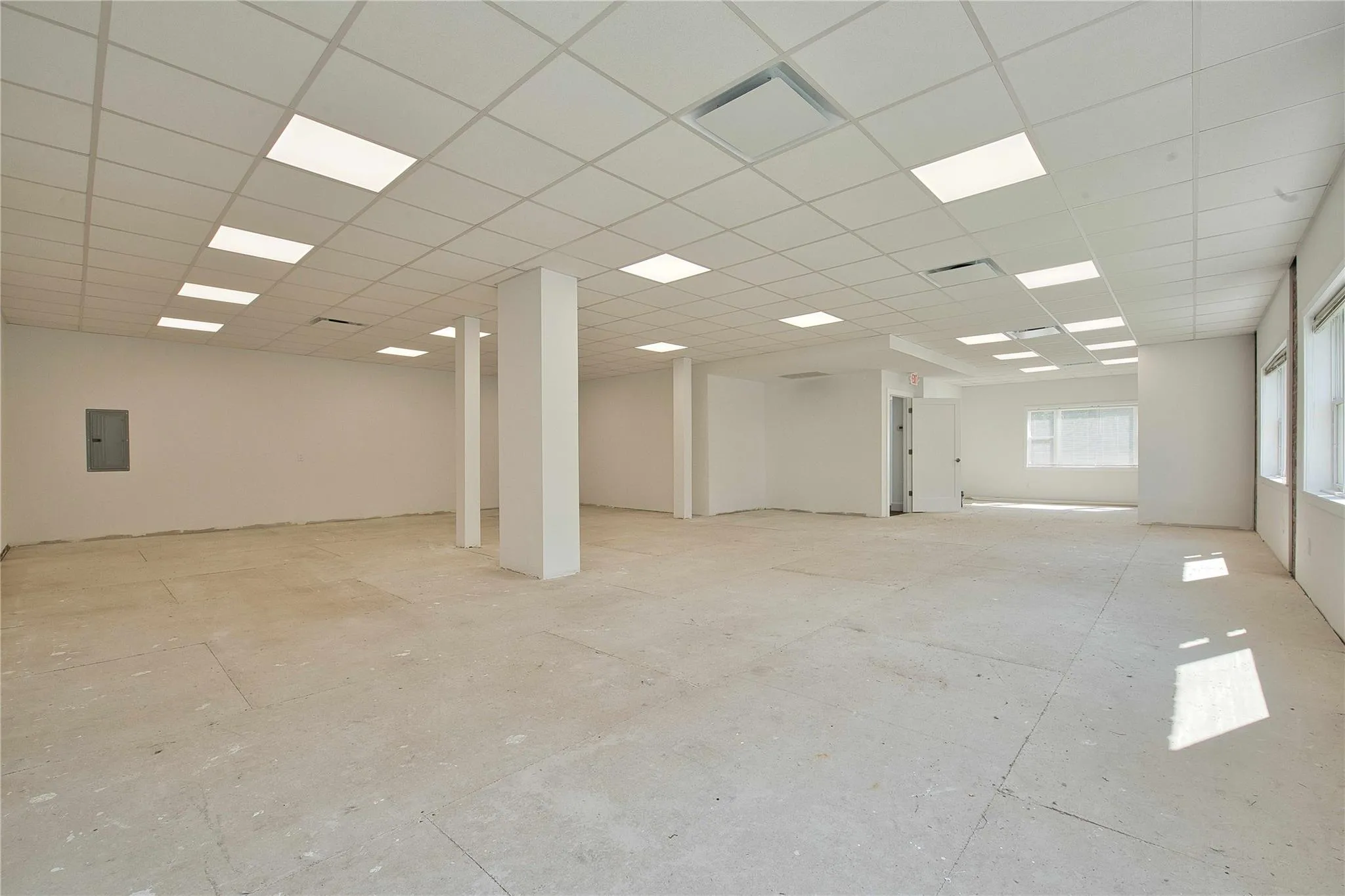 Spare room with electric panel and a drop ceiling Spare room with electric panel and a drop ceiling