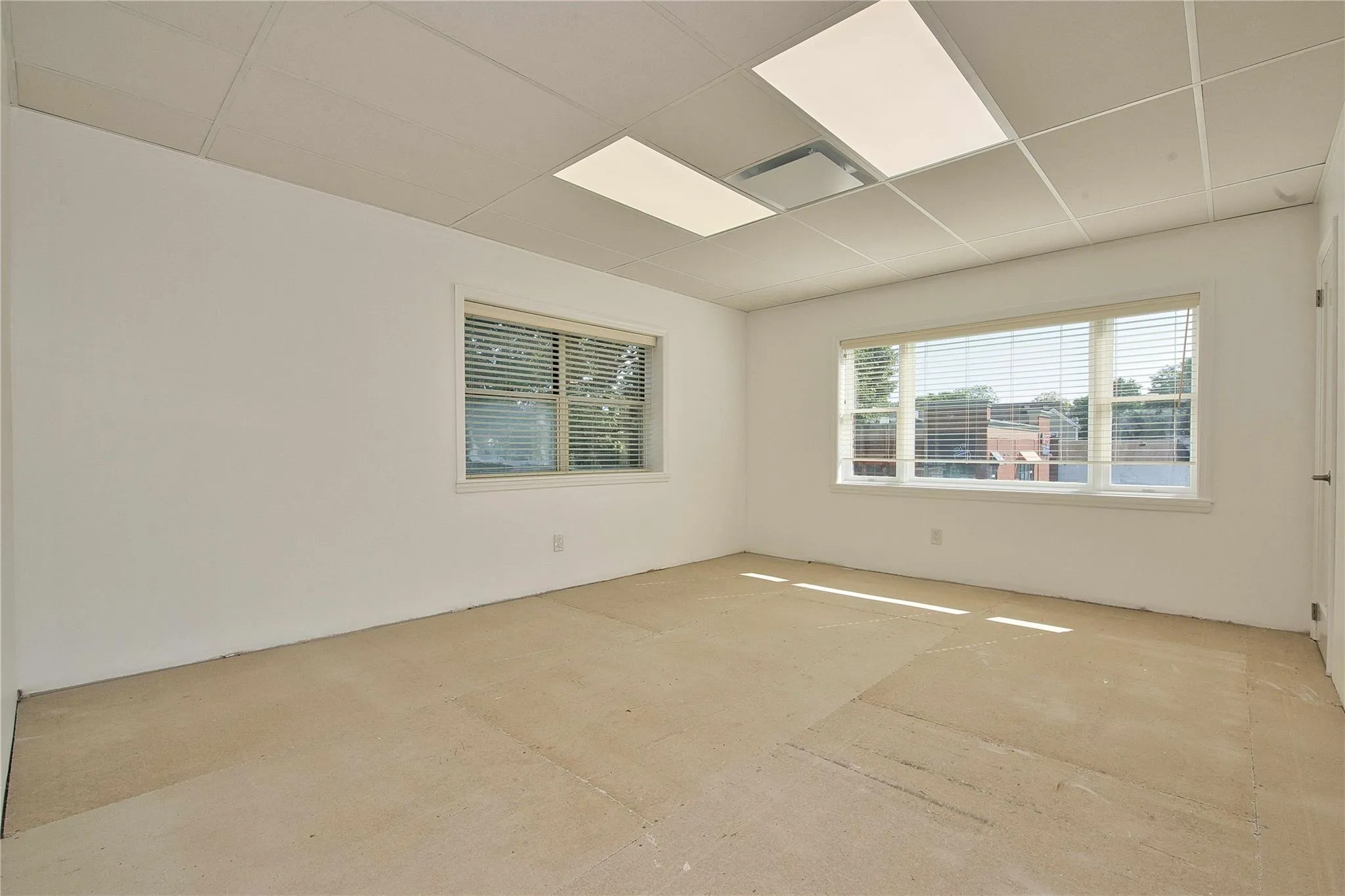 Unfurnished room featuring a drop ceiling Unfurnished room featuring a drop ceiling