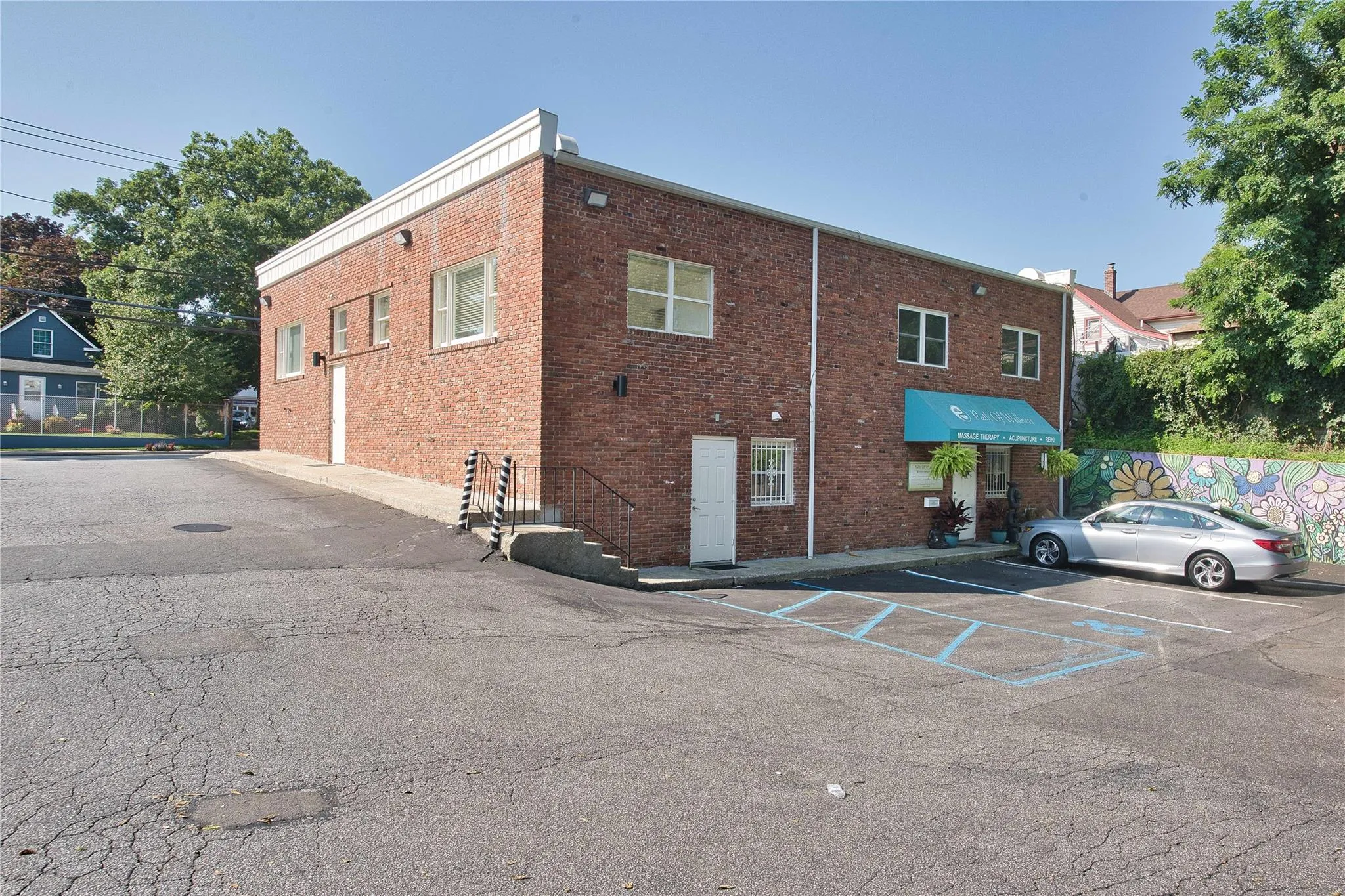 View of building exterior featuring uncovered parking View of building exterior featuring uncovered parking