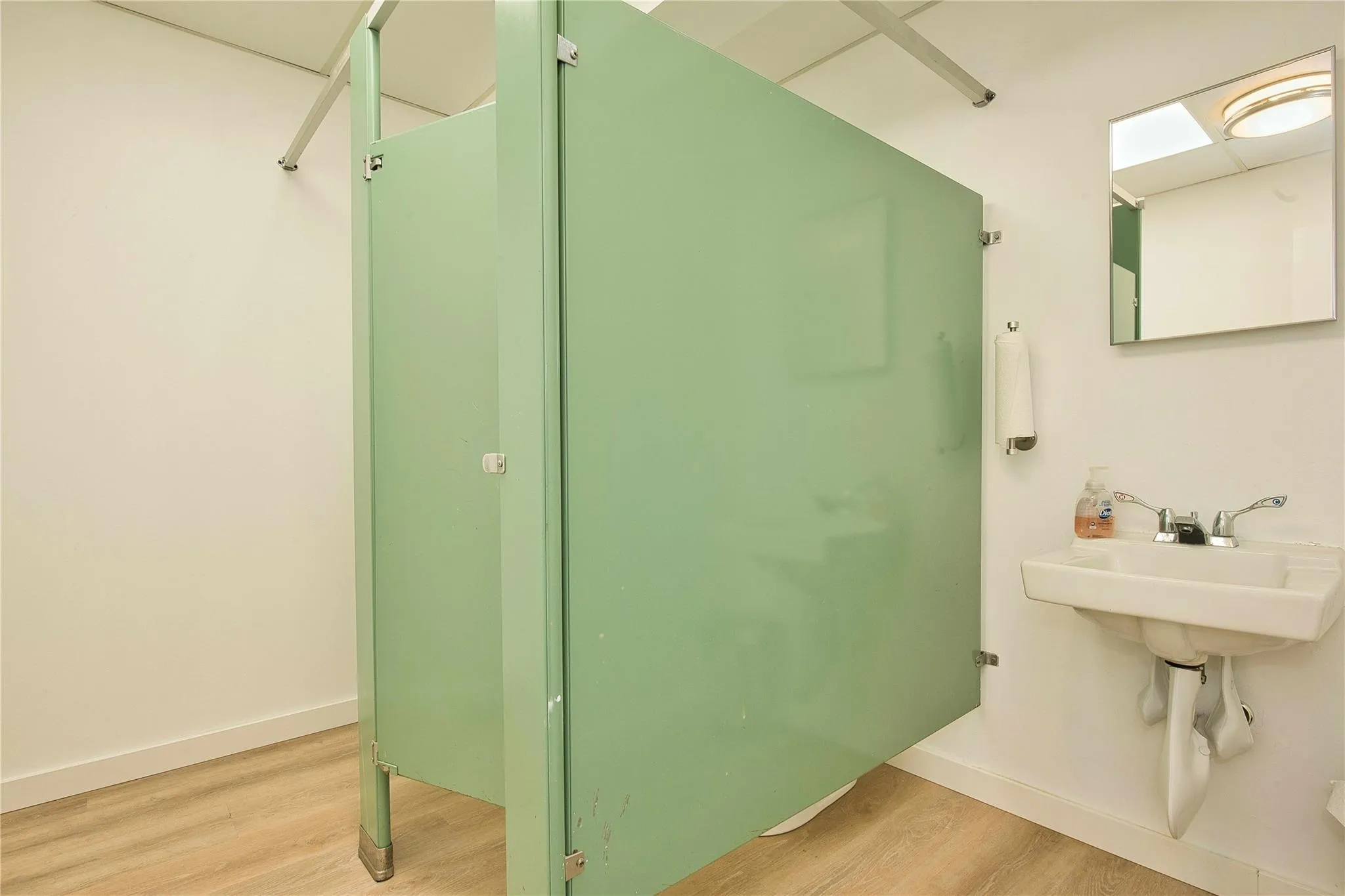 Bathroom featuring wood finished floors and baseboards Bathroom featuring wood finished floors and baseboards