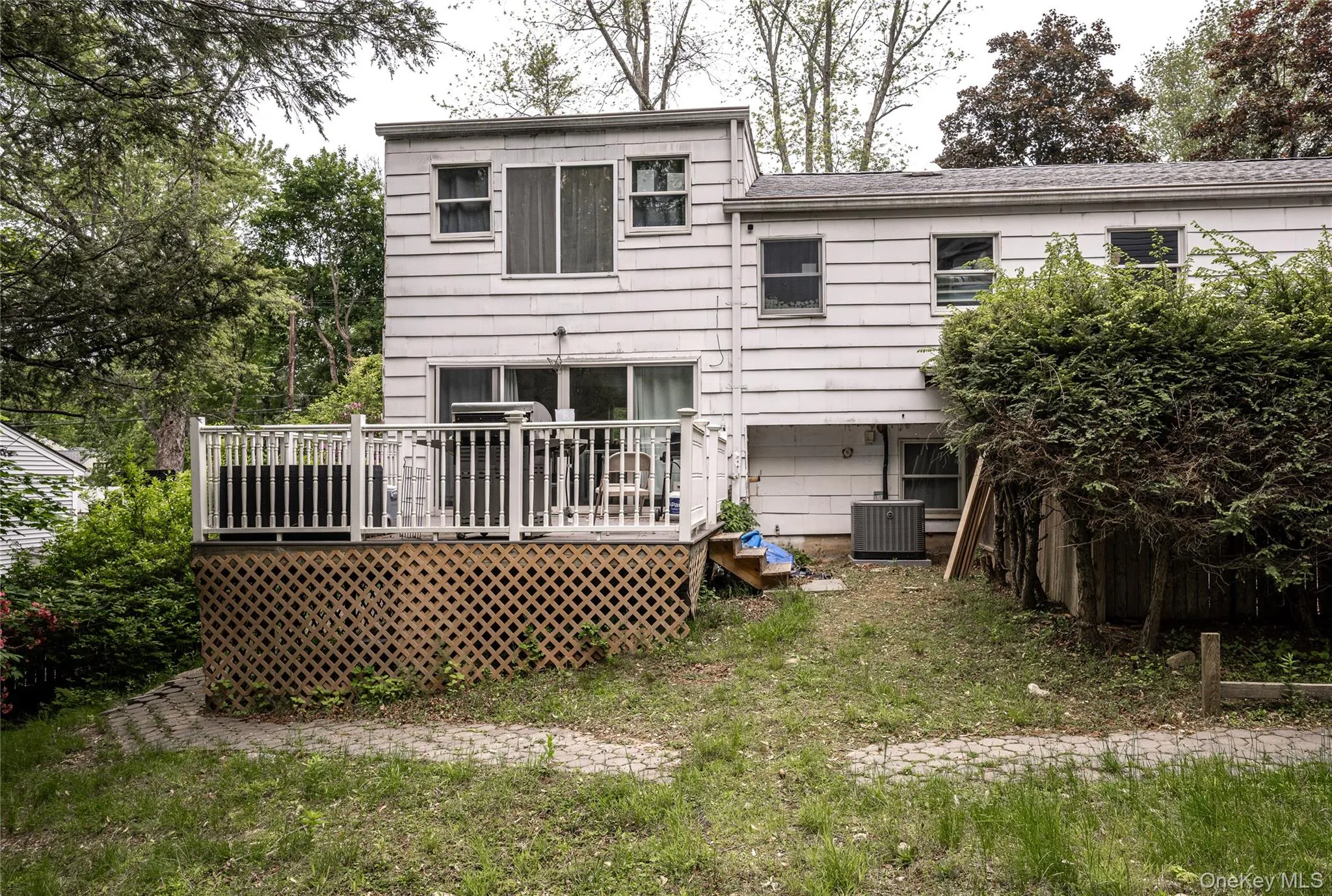 Back of house featuring a deck and central AC Back of house featuring a deck and central AC