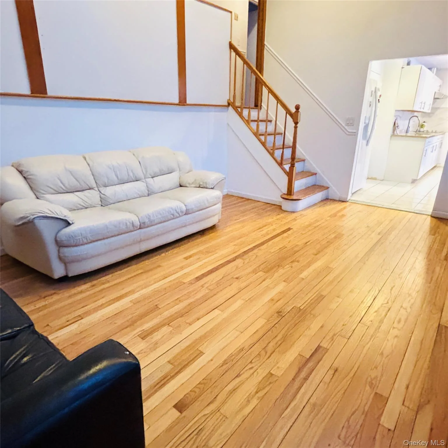 Living room with stairway to bedroom level which features 5 bedrooms Living room with stairway to bedroom level which features 5 bedrooms