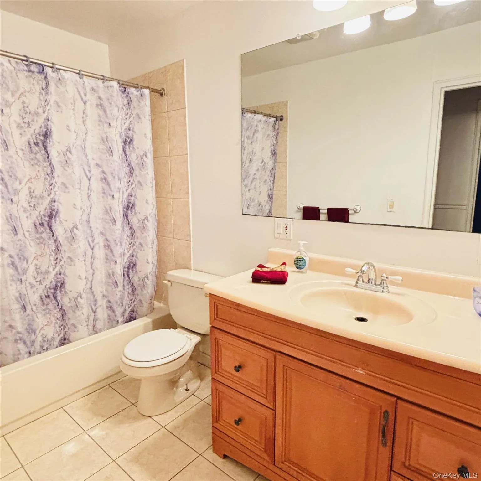 Bedroom level Bathroom featuring vanity, shower / tub combo Bedroom level Bathroom featuring vanity, shower / tub combo