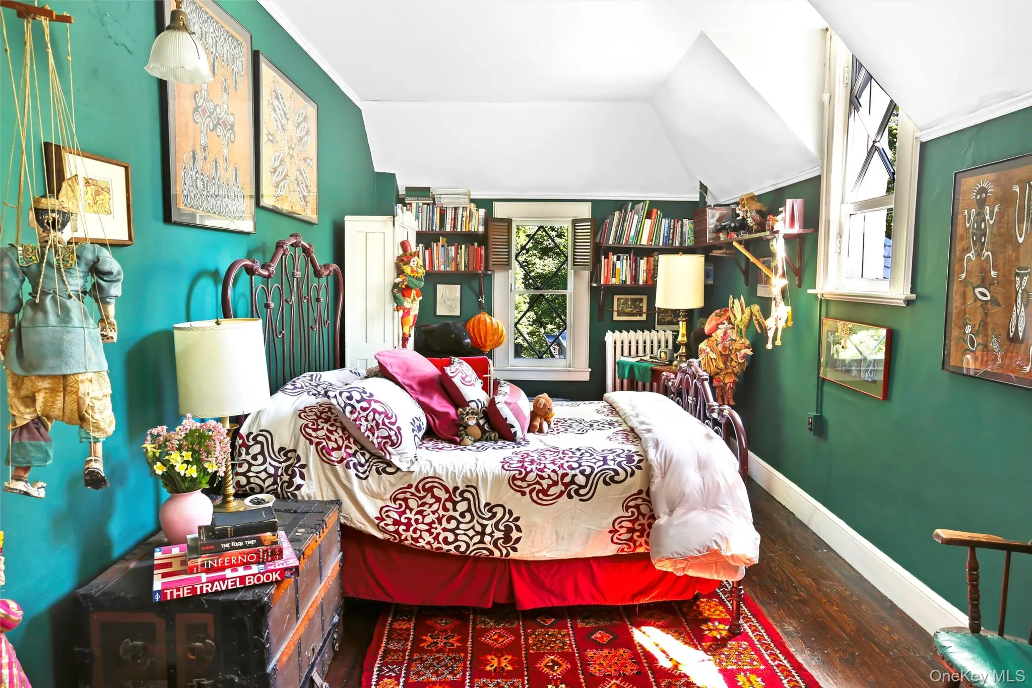 Bedroom featuring wood finished floors, vaulted ceiling, baseboards, and radiator Bedroom featuring wood finished floors, vaulted ceiling, baseboards, and radiator