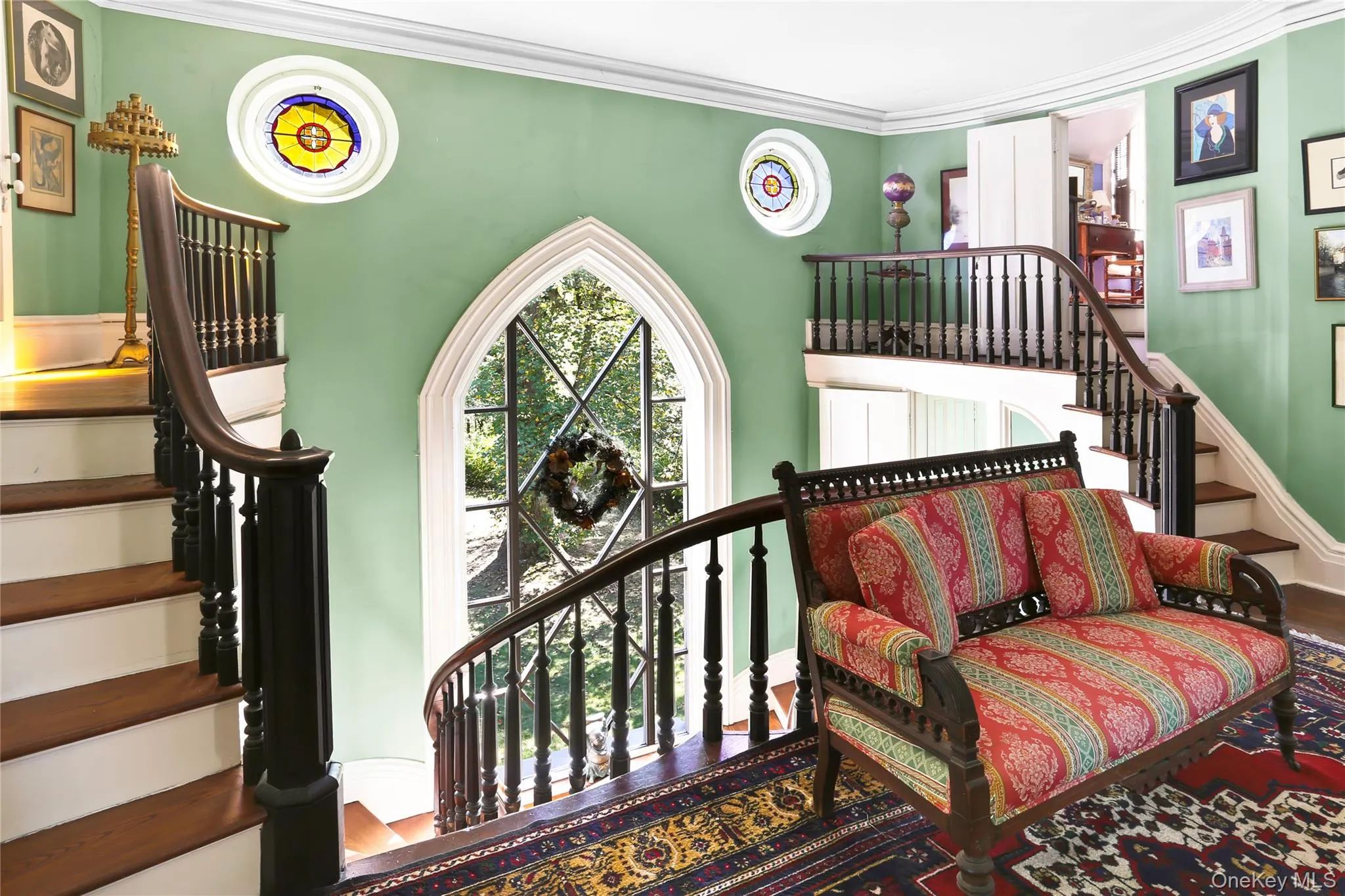 Staircase featuring crown molding, baseboards, and wood finished floors Staircase featuring crown molding, baseboards, and wood finished floors