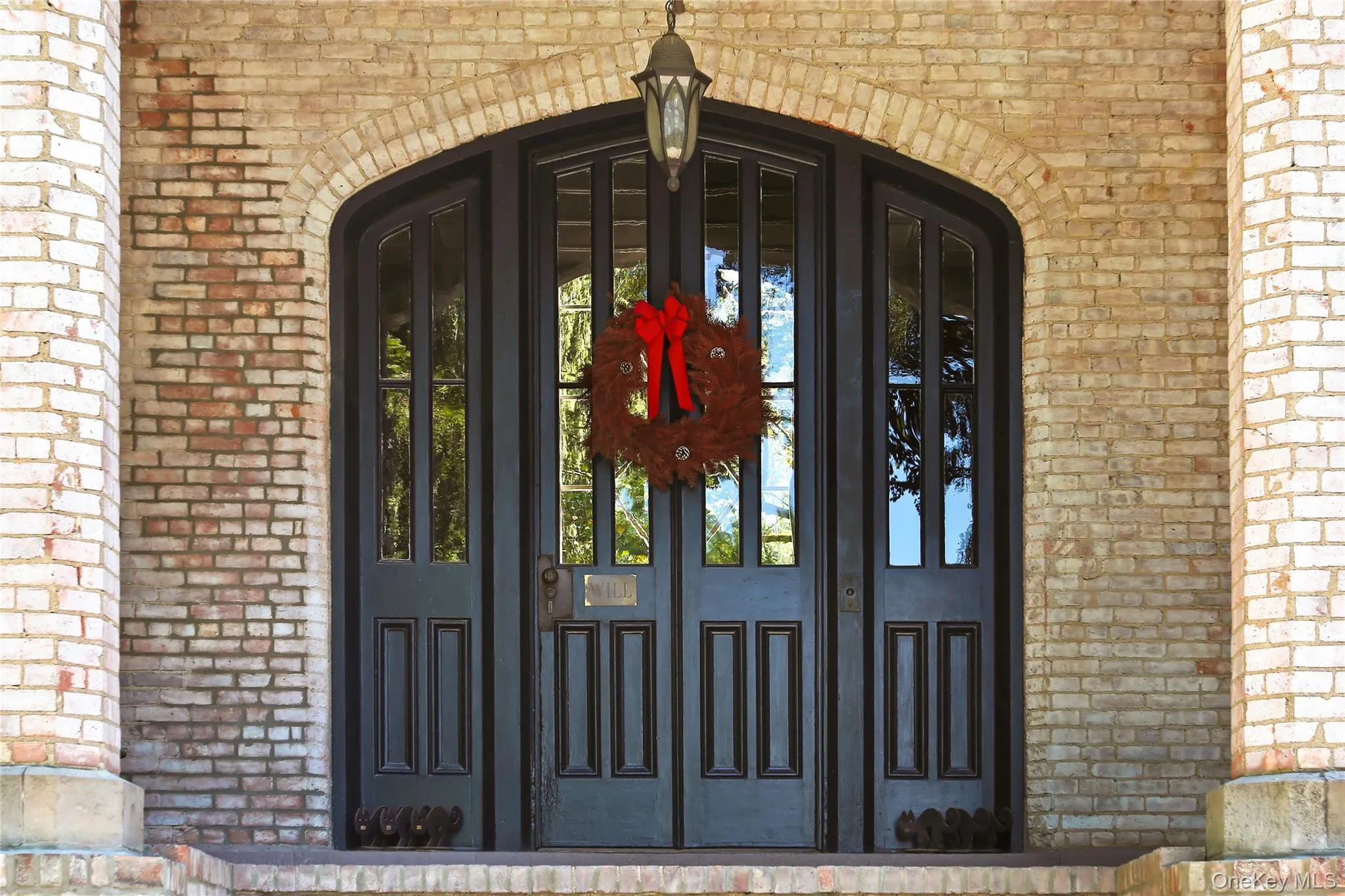 Property entrance featuring brick siding Property entrance featuring brick siding