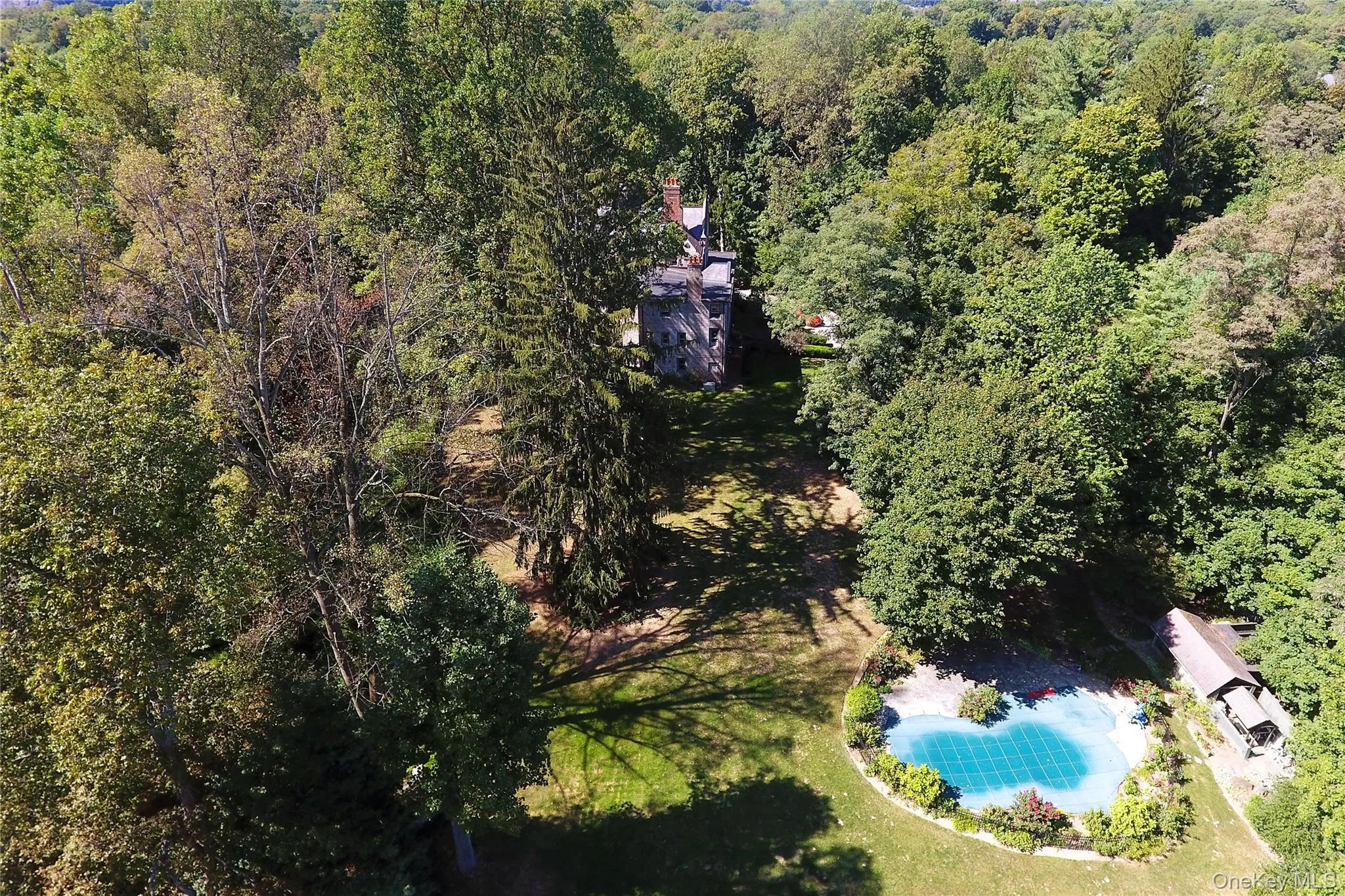 Drone / aerial view of home and a pool Drone / aerial view of home and a pool