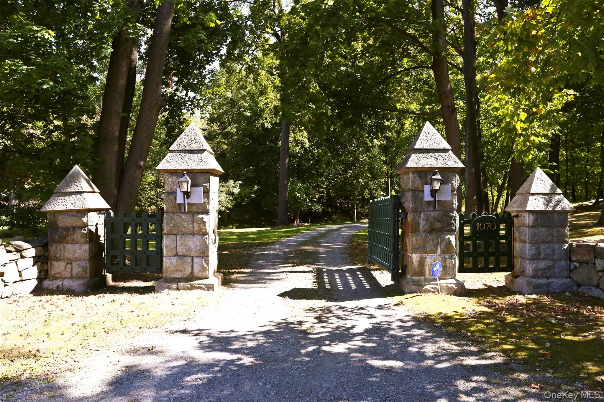 View of dirt / gravel driveway with a gate and a gated entry View of dirt / gravel driveway with a gate and a gated entry