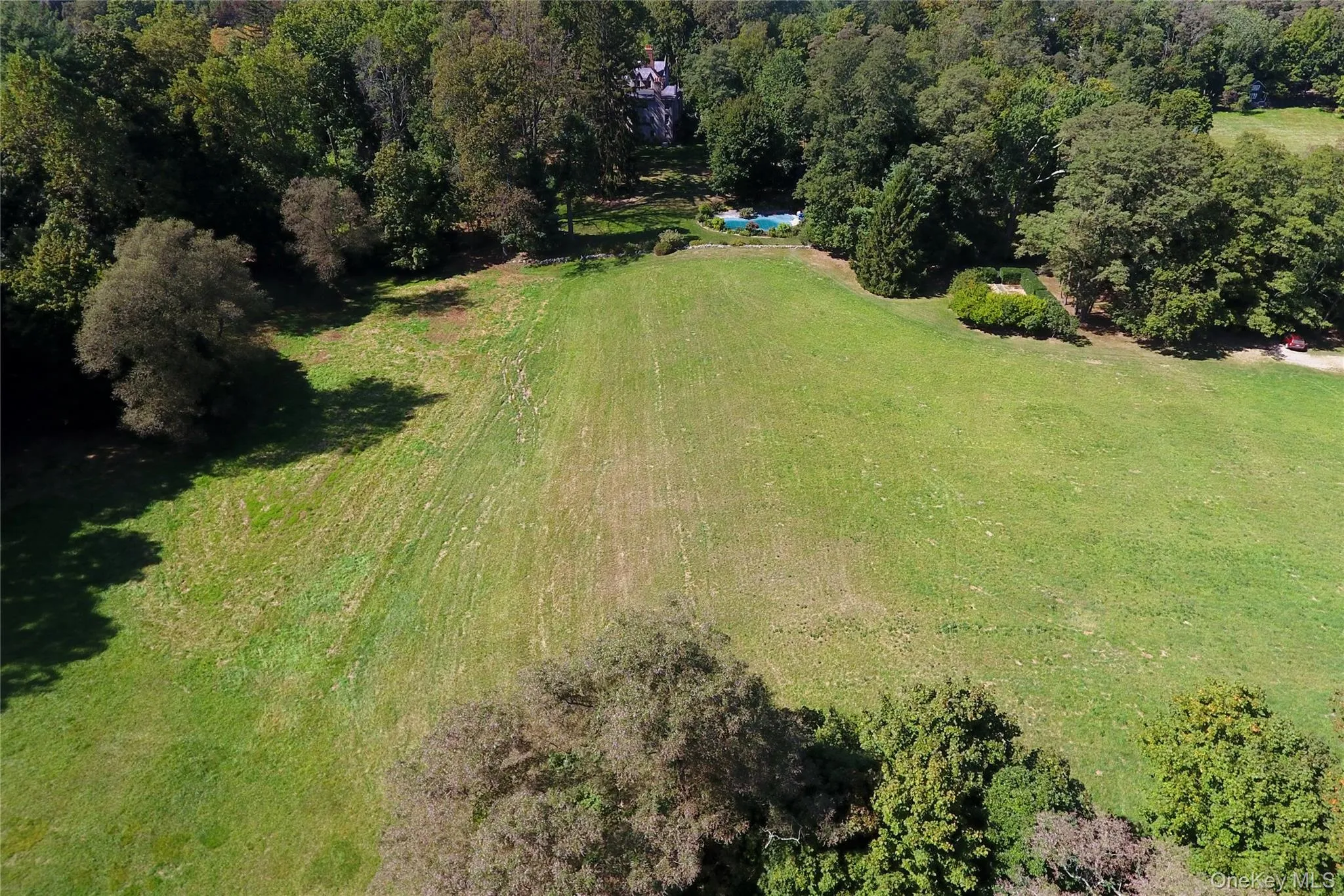 Aerial overview of property's location with a forest Aerial overview of property's location with a forest