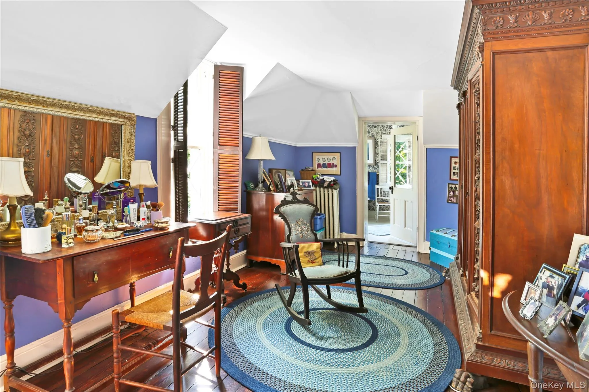 Sitting room with vaulted ceiling, wood finished floors, and baseboards Sitting room with vaulted ceiling, wood finished floors, and baseboards