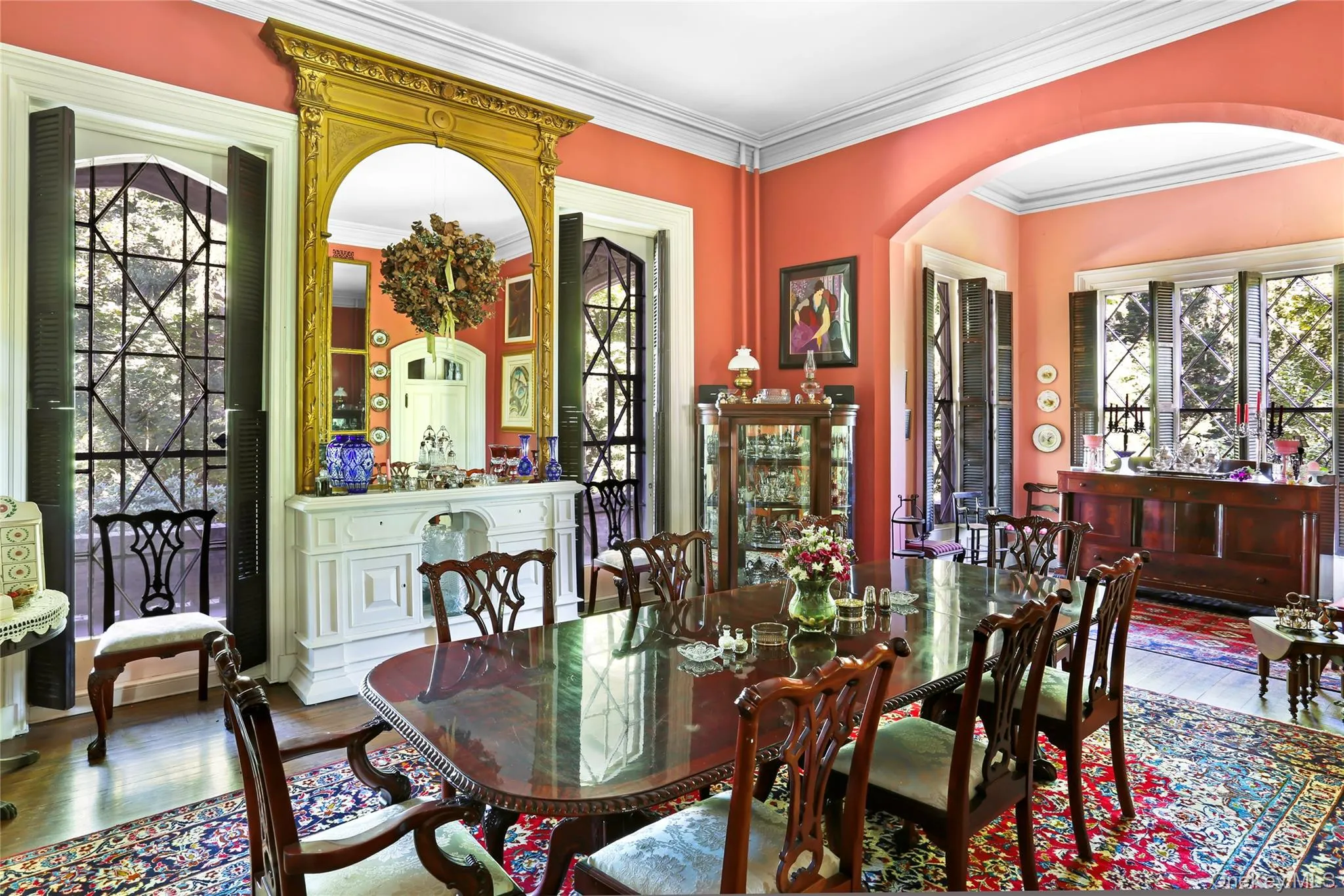 Dining area featuring arched walkways, wood finished floors, and ornamental molding Dining area featuring arched walkways, wood finished floors, and ornamental molding