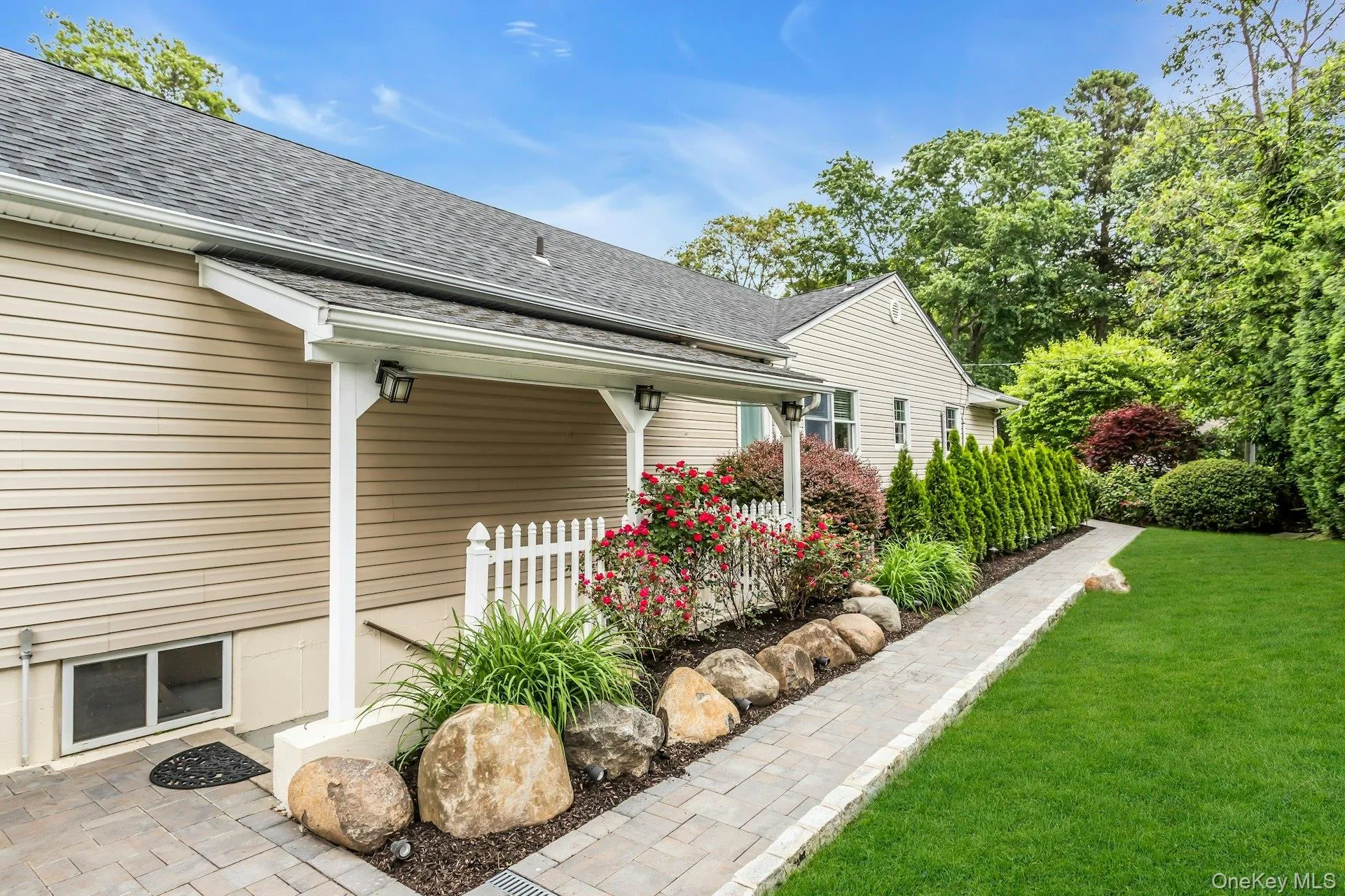 View of side of property with a shingled roof and a yard View of side of property with a shingled roof and a yard