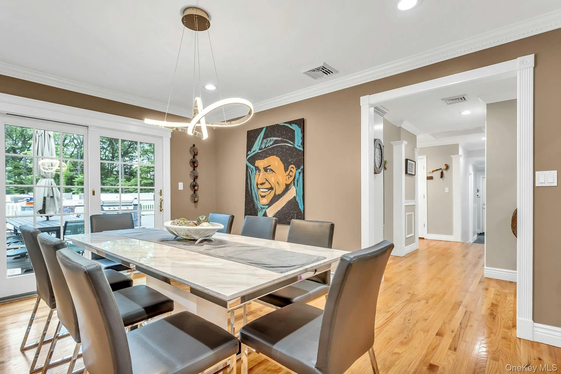 Dining room featuring light wood-style flooring, a chandelier, crown molding, baseboards, and recessed lighting Dining room featuring light wood-style flooring, a chandelier, crown molding, baseboards, and recessed lighting