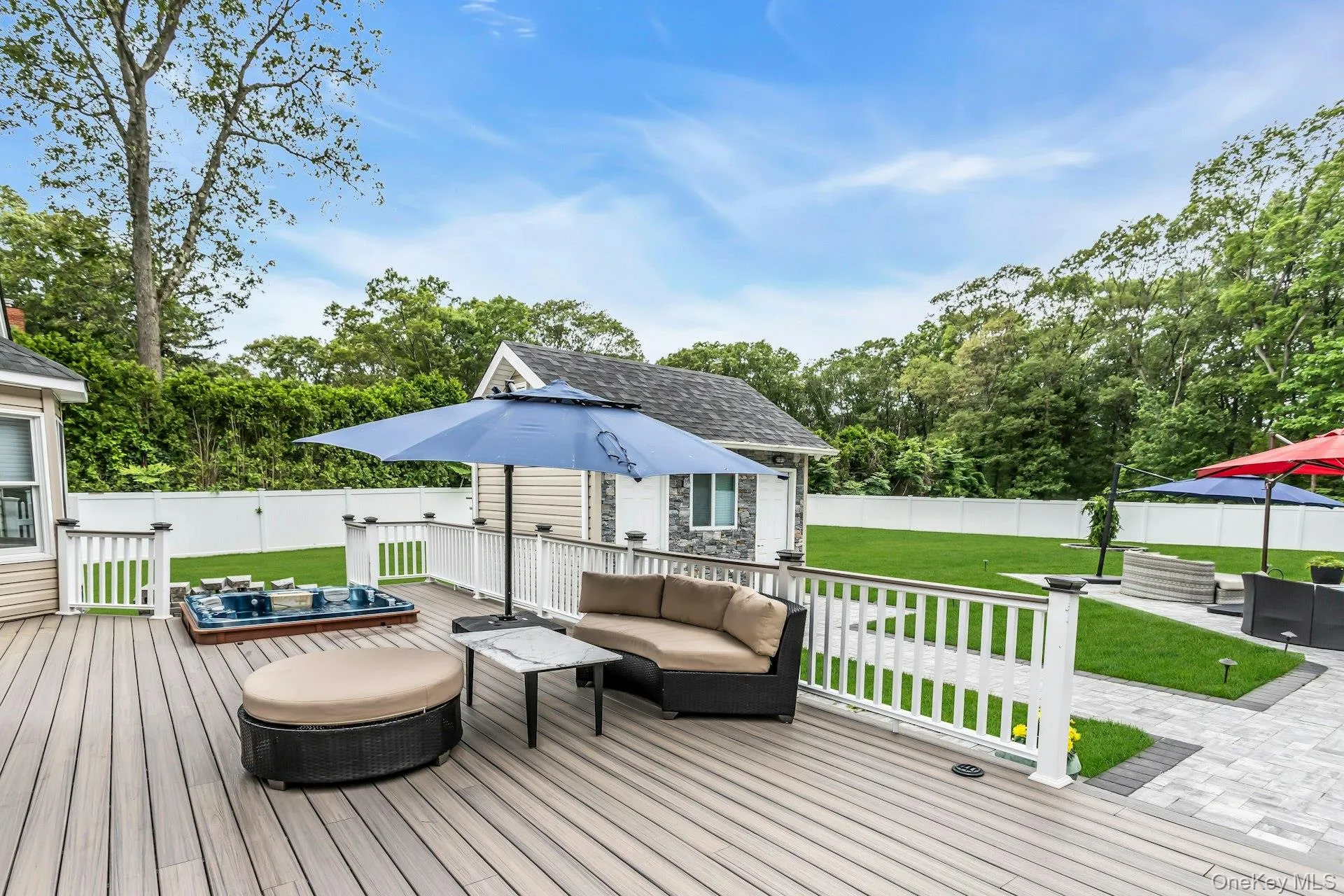 Deck featuring an outdoor living space, view of scattered trees, and an outbuilding Deck featuring an outdoor living space, view of scattered trees, and an outbuilding