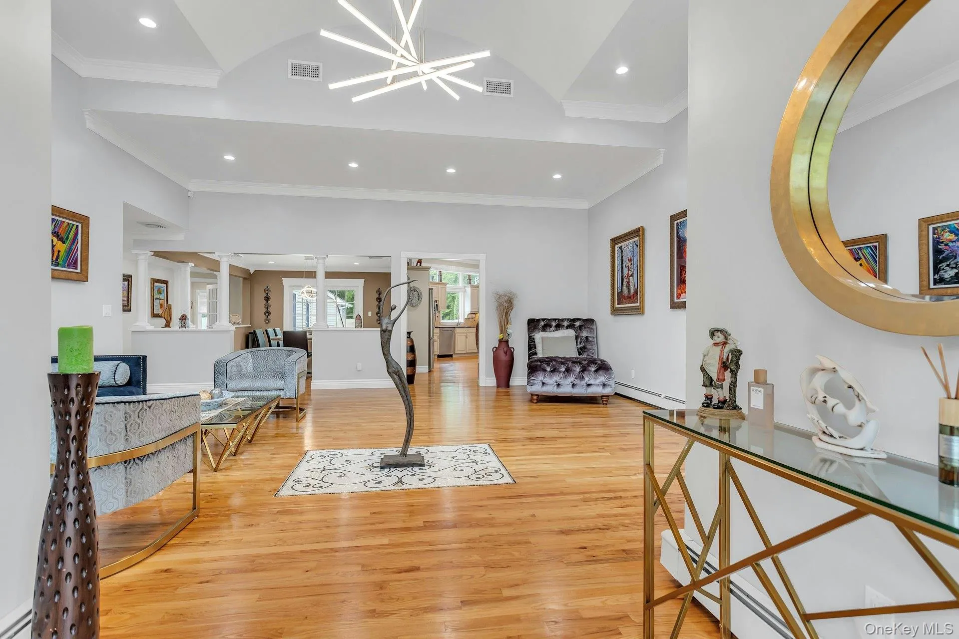 Entryway featuring a baseboard heating unit, ornamental molding, light wood finished floors, recessed lighting, and baseboard heating Entryway featuring a baseboard heating unit, ornamental molding, light wood finished floors, recessed lighting, and baseboard heating