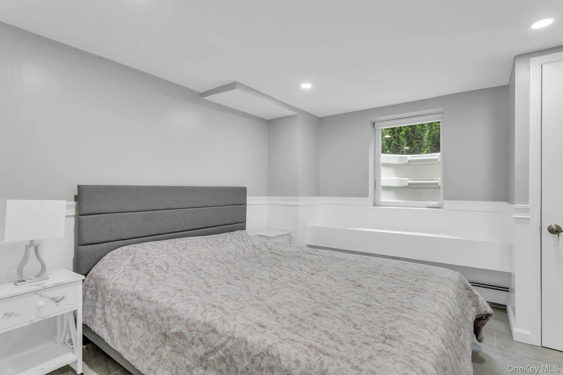 Bedroom with recessed lighting and a baseboard heating unit Bedroom with recessed lighting and a baseboard heating unit