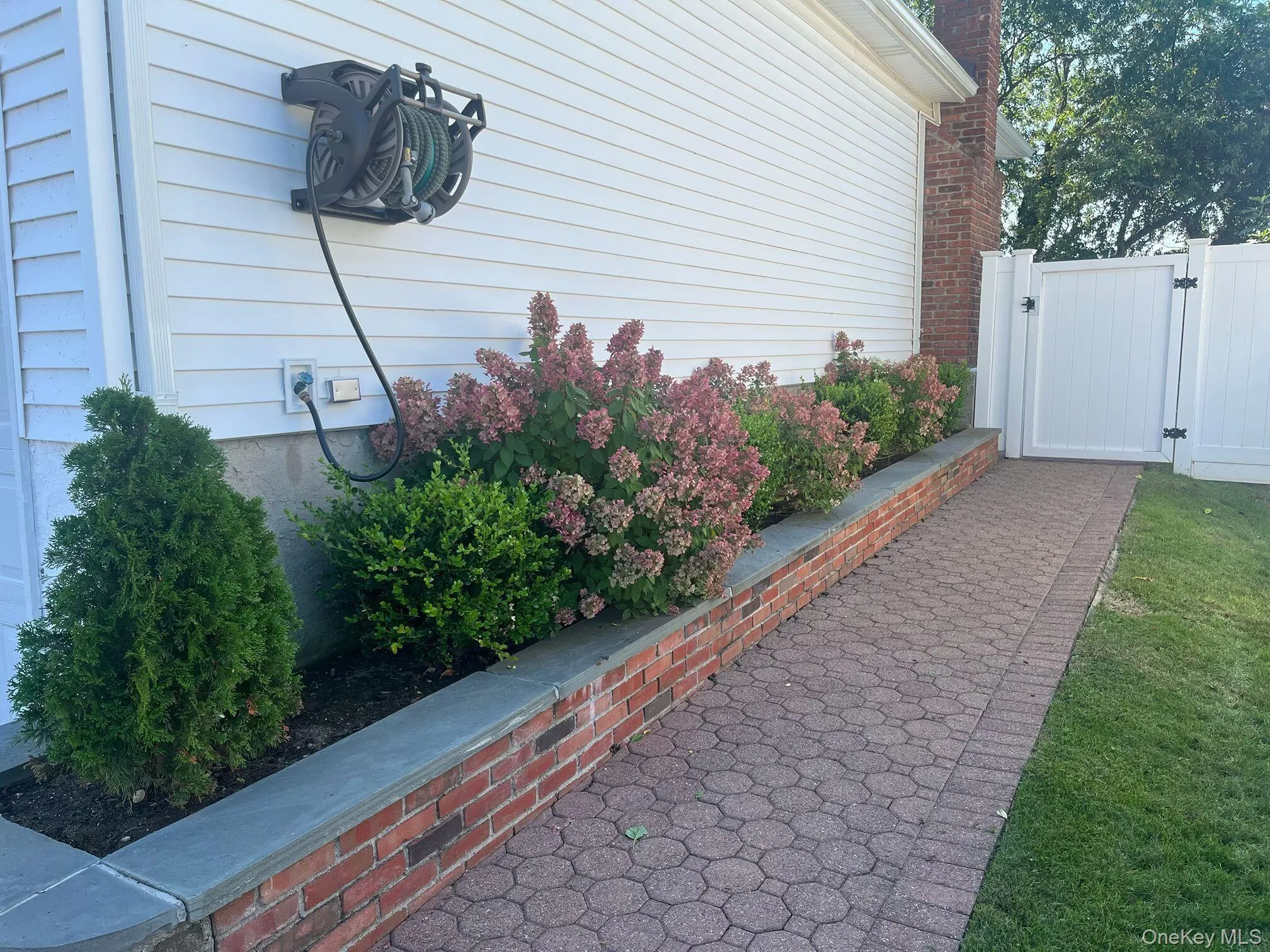 View of side of property with a gate and a chimney View of side of property with a gate and a chimney
