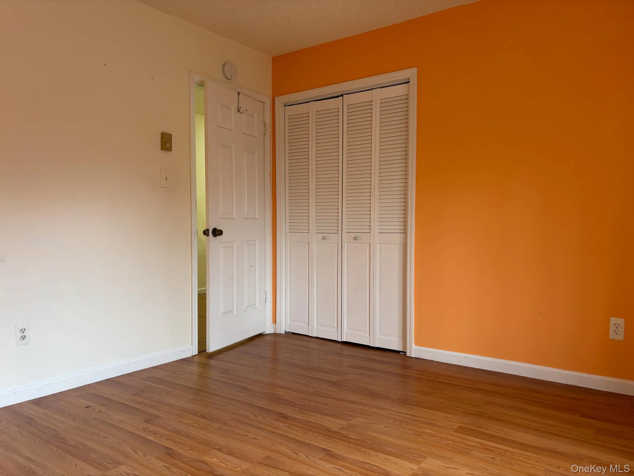 Unfurnished bedroom featuring light wood-style floors and a closet Unfurnished bedroom featuring light wood-style floors and a closet