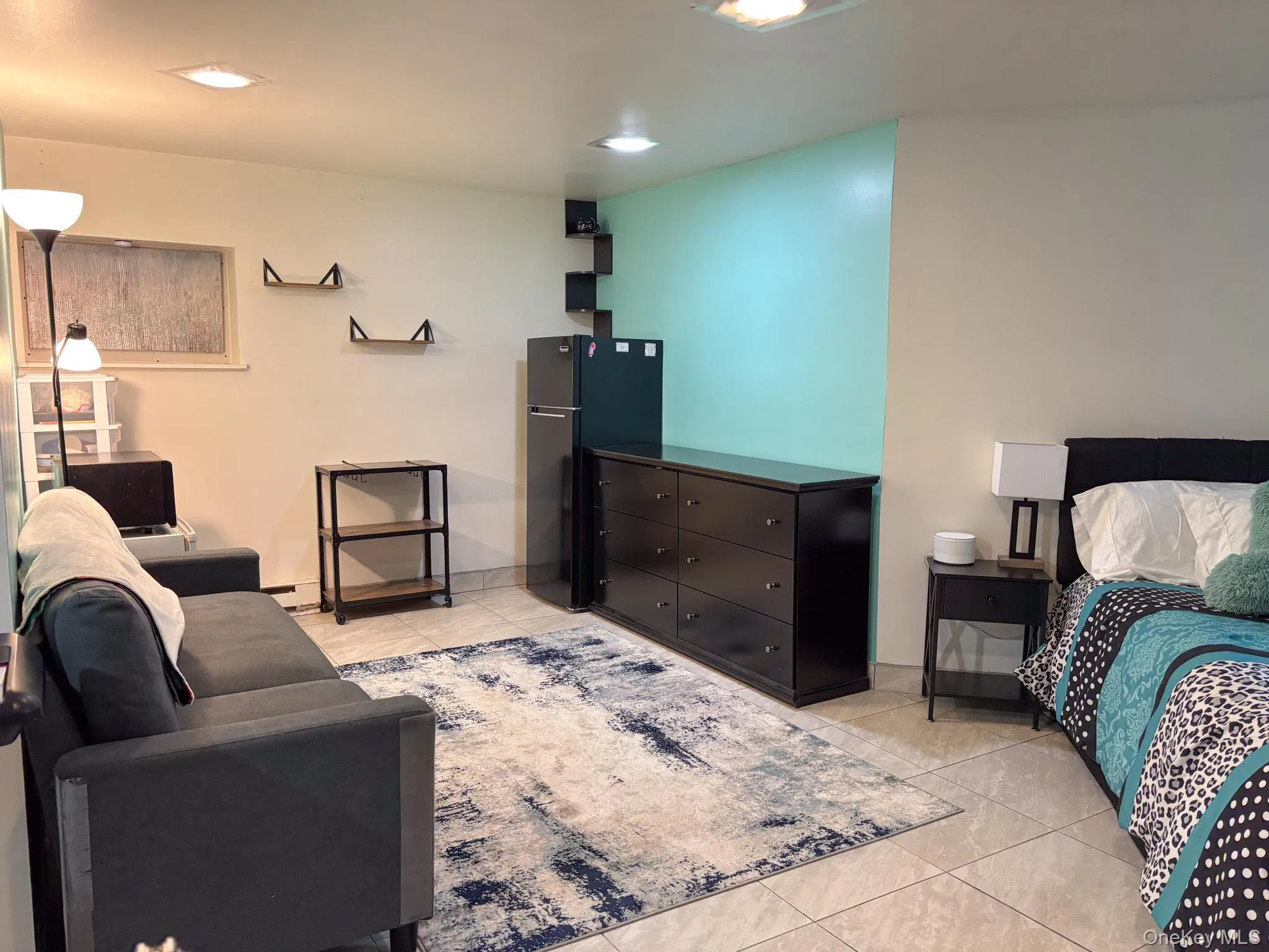 Basement featuring light tile patterned flooring, baseboard heating, and recessed lighting Basement featuring light tile patterned flooring, baseboard heating, and recessed lighting