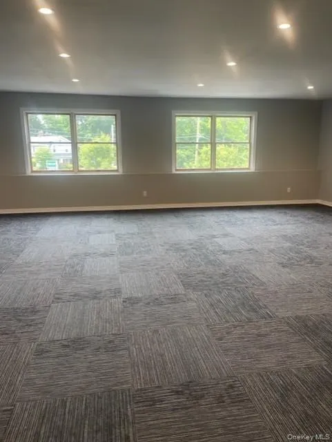 Unfurnished room featuring dark carpet, recessed lighting, and baseboards Unfurnished room featuring dark carpet, recessed lighting, and baseboards
