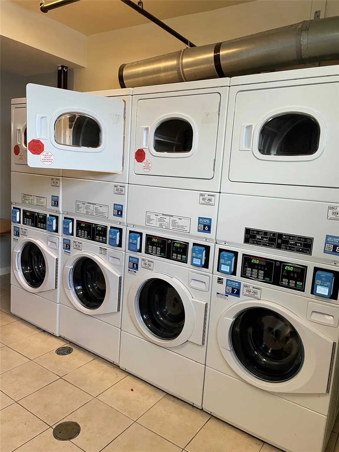 Shared laundry featuring stacked washer and clothes dryer Shared laundry featuring stacked washer and clothes dryer
