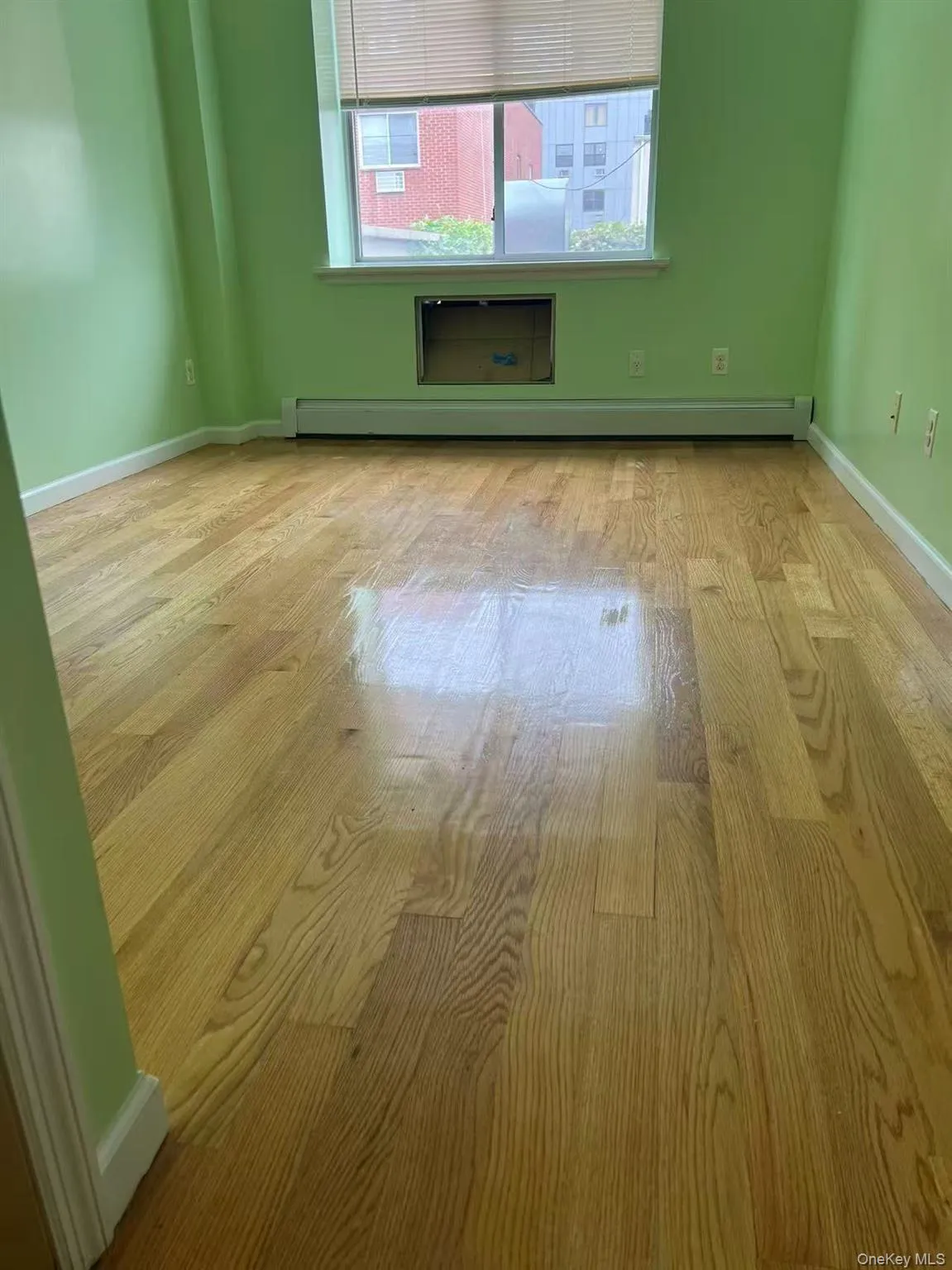 Empty room with baseboards and a baseboard radiator Empty room with baseboards and a baseboard radiator