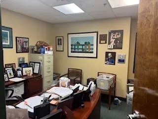 Office area with a paneled ceiling and carpet Office area with a paneled ceiling and carpet