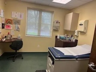 Bedroom with a drop ceiling and baseboards Bedroom with a drop ceiling and baseboards