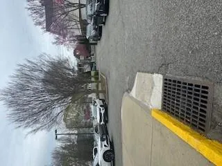 View of asphalt street featuring street lights and sidewalks View of asphalt street featuring street lights and sidewalks