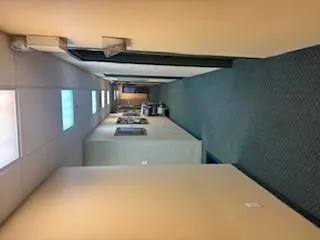 Corridor with carpet and a paneled ceiling Corridor with carpet and a paneled ceiling