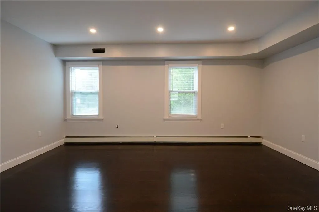 Unfurnished room featuring baseboards, plenty of natural light, a baseboard heating unit, and recessed lighting Unfurnished room featuring baseboards, plenty of natural light, a baseboard heating unit, and recessed lighting
