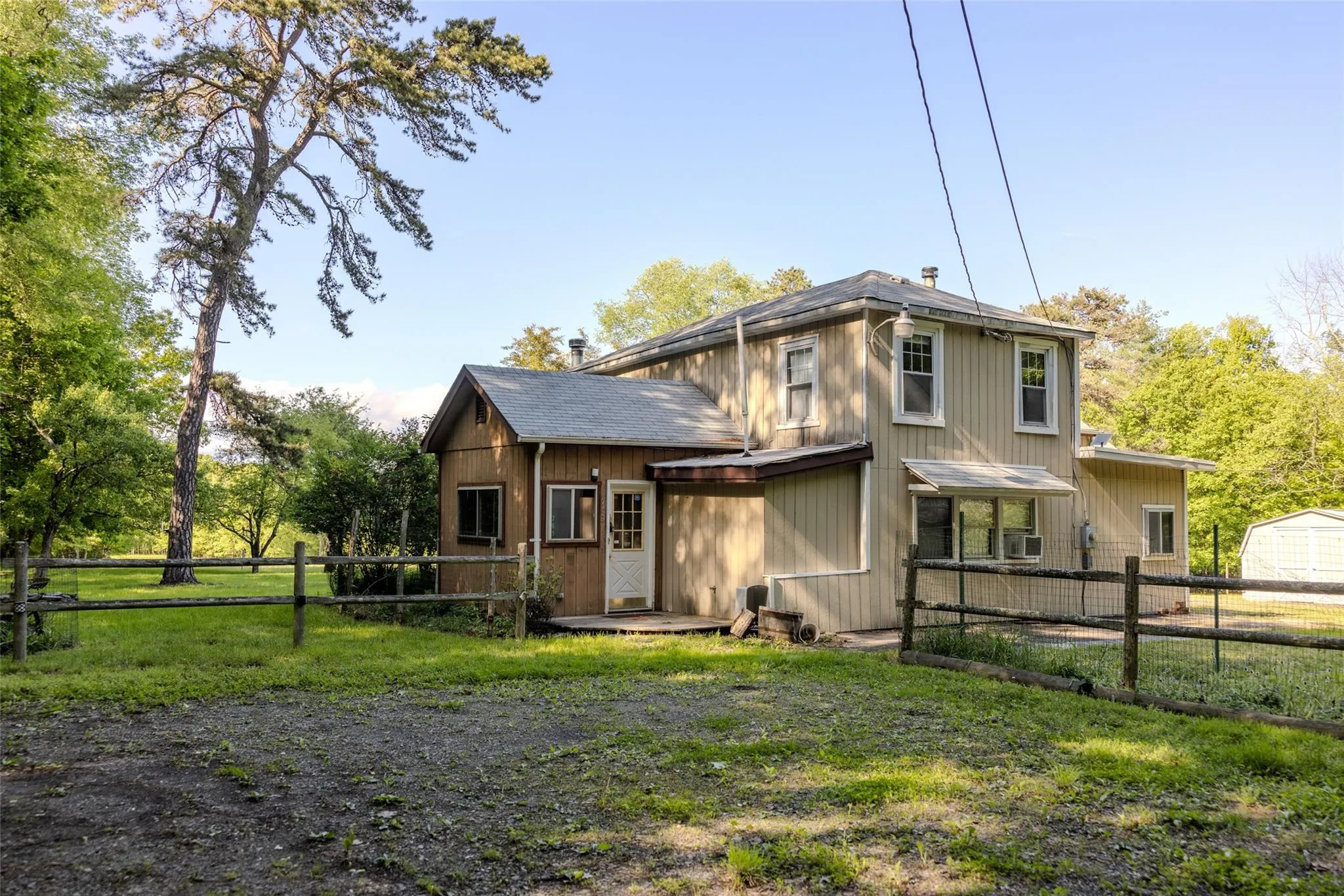 Rear view of property with a shingled roof Rear view of property with a shingled roof
