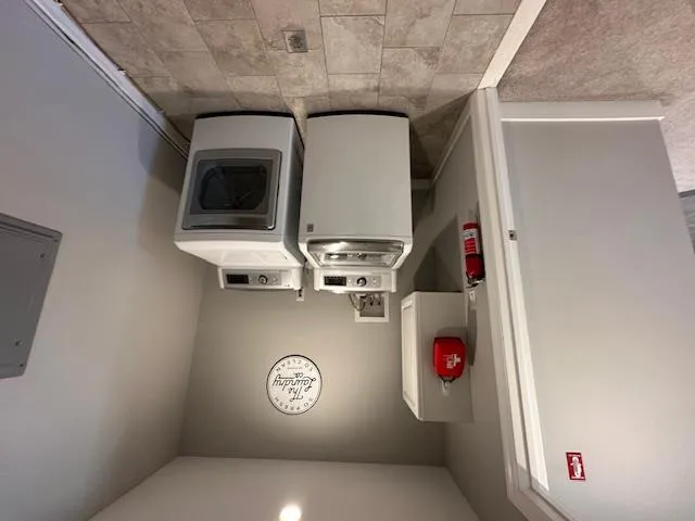 Washroom featuring washer and clothes dryer, baseboards, and electric panel Washroom featuring washer and clothes dryer, baseboards, and electric panel