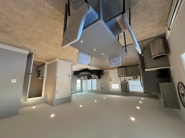 Dining room with baseboard heating, recessed lighting, baseboards, light colored carpet, and washer / dryer Dining room with baseboard heating, recessed lighting, baseboards, light colored carpet, and washer / dryer