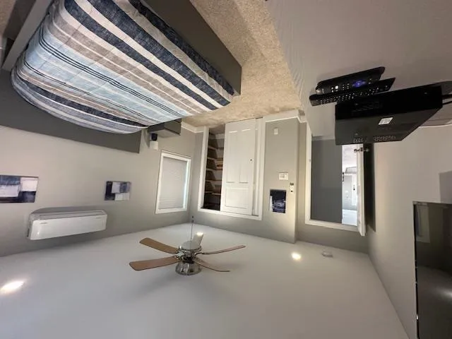 Carpeted bedroom with ductless AC, a closet, baseboards, recessed lighting, and a ceiling fan Carpeted bedroom with ductless AC, a closet, baseboards, recessed lighting, and a ceiling fan