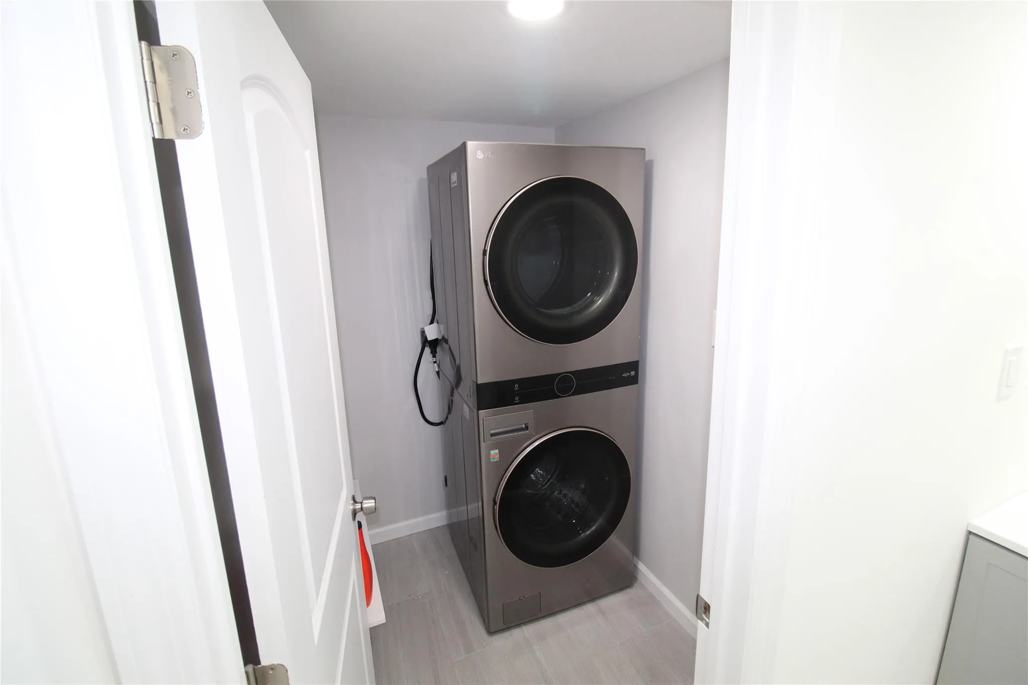 Laundry area with estacked washer and dryer and baseboards Laundry area with estacked washer and dryer and baseboards