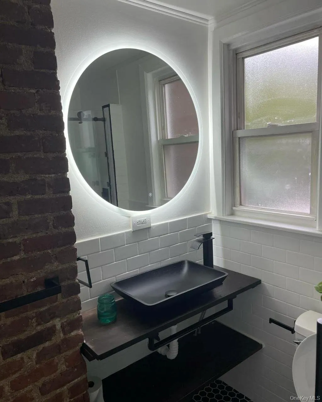 Half bathroom featuring decorative backsplash and tile walls Half bathroom featuring decorative backsplash and tile walls
