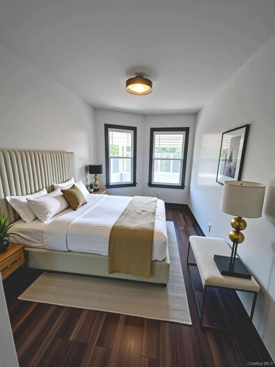 Bedroom featuring dark wood-style floors and baseboards Bedroom featuring dark wood-style floors and baseboards