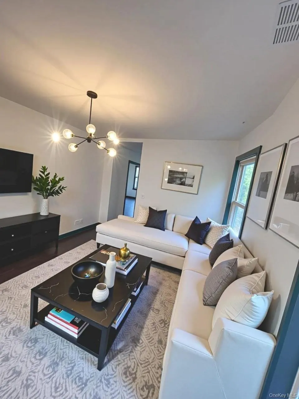 Living area featuring a chandelier Living area featuring a chandelier