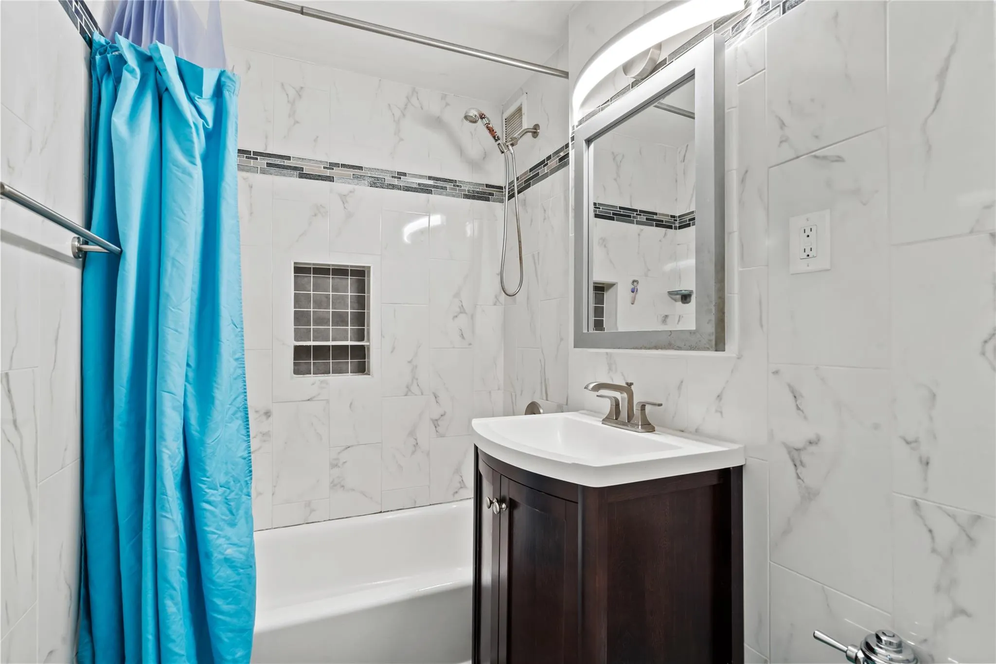 Bathroom with shower / bath combo with shower curtain, vanity, and tile walls Bathroom with shower / bath combo with shower curtain, vanity, and tile walls