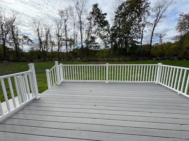Wooden terrace featuring a yard Wooden terrace featuring a yard