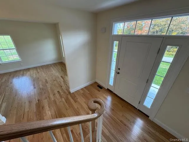 Foyer with healthy amount of natural light and light wood finished floors Foyer with healthy amount of natural light and light wood finished floors
