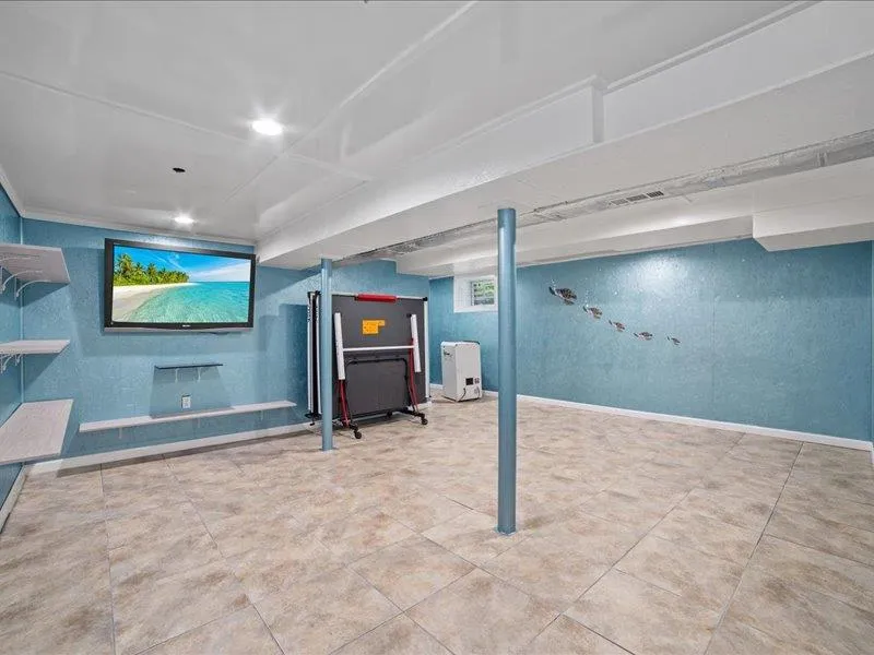 Finished basement featuring tile patterned flooring Finished basement featuring tile patterned flooring