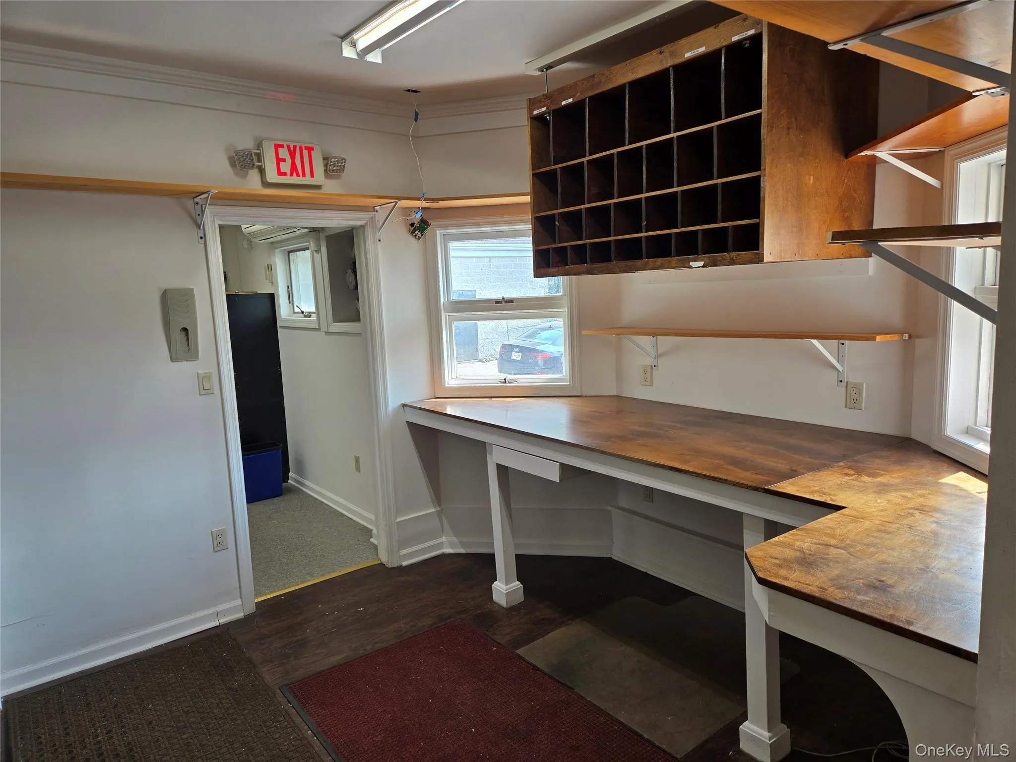 Unfurnished office featuring wood finished floors and baseboards Unfurnished office featuring wood finished floors and baseboards