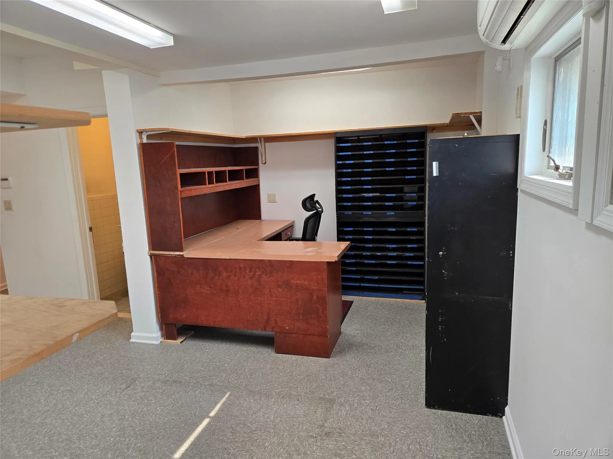 Office with a wall mounted AC and carpet Office with a wall mounted AC and carpet