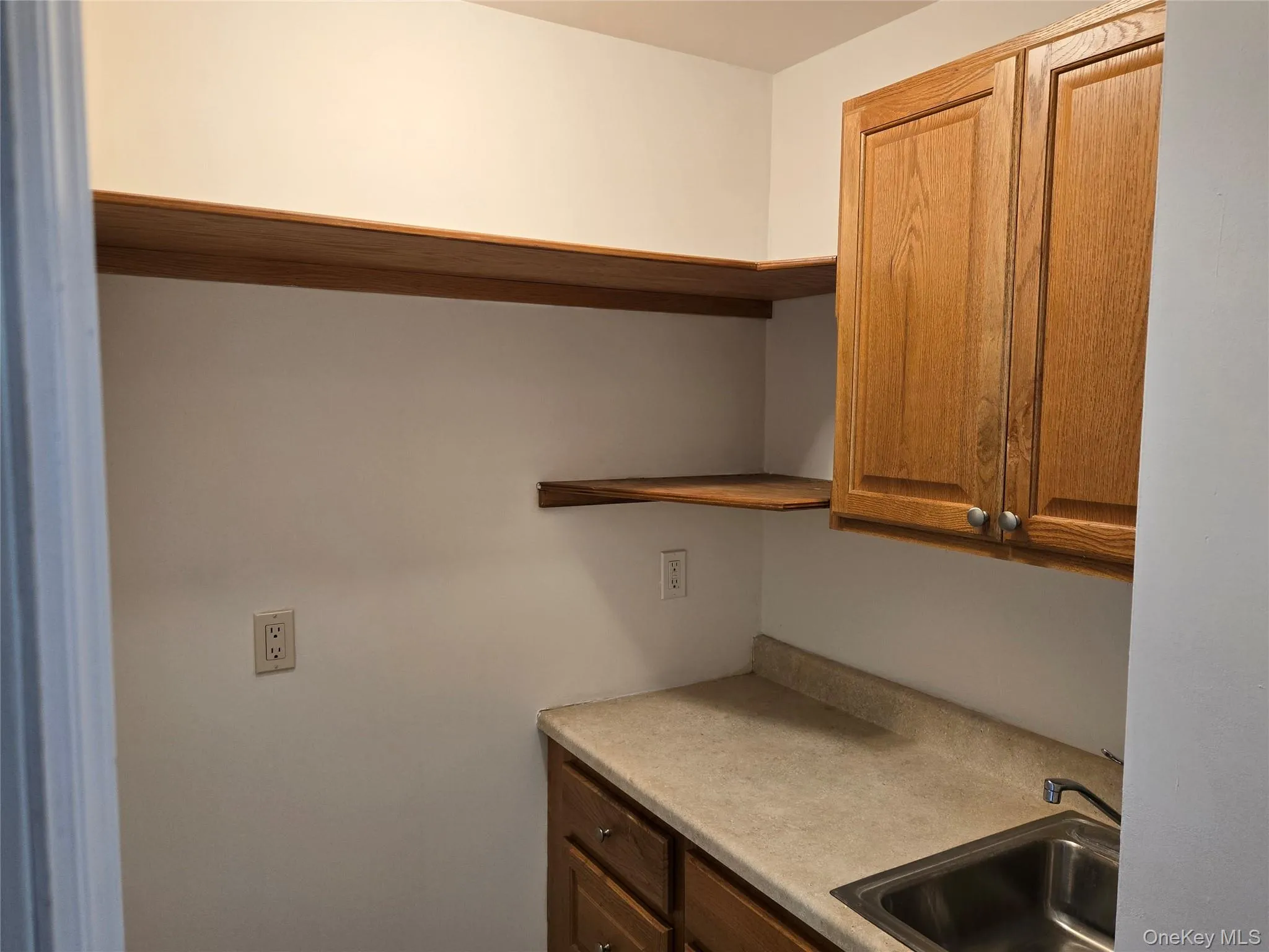 Kitchen with a sink and light countertops Kitchen with a sink and light countertops