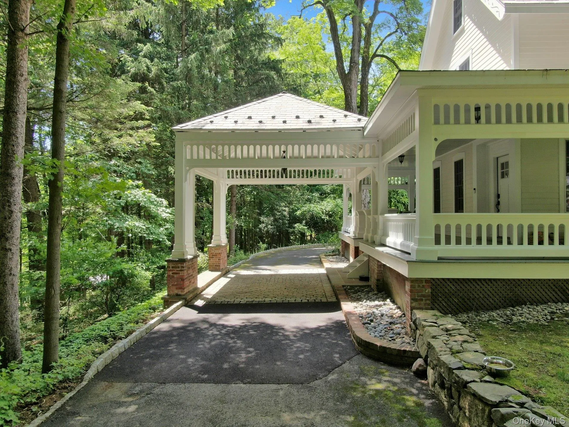 View of patio / terrace featuring driveway, a gazebo, and a carport View of patio / terrace featuring driveway, a gazebo, and a carport
