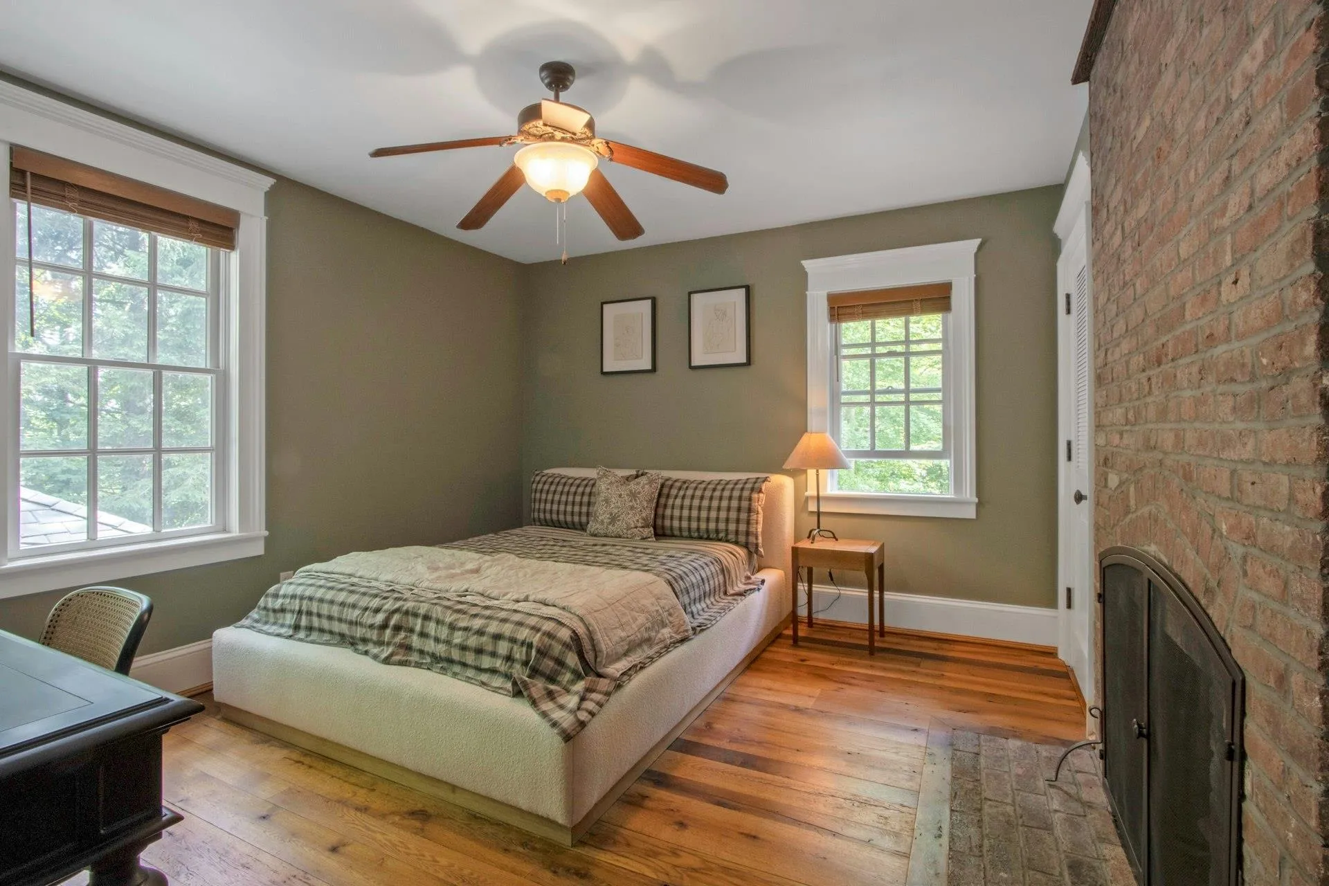 Bedroom with baseboards, hardwood / wood-style floors, and ceiling fan Bedroom with baseboards, hardwood / wood-style floors, and ceiling fan