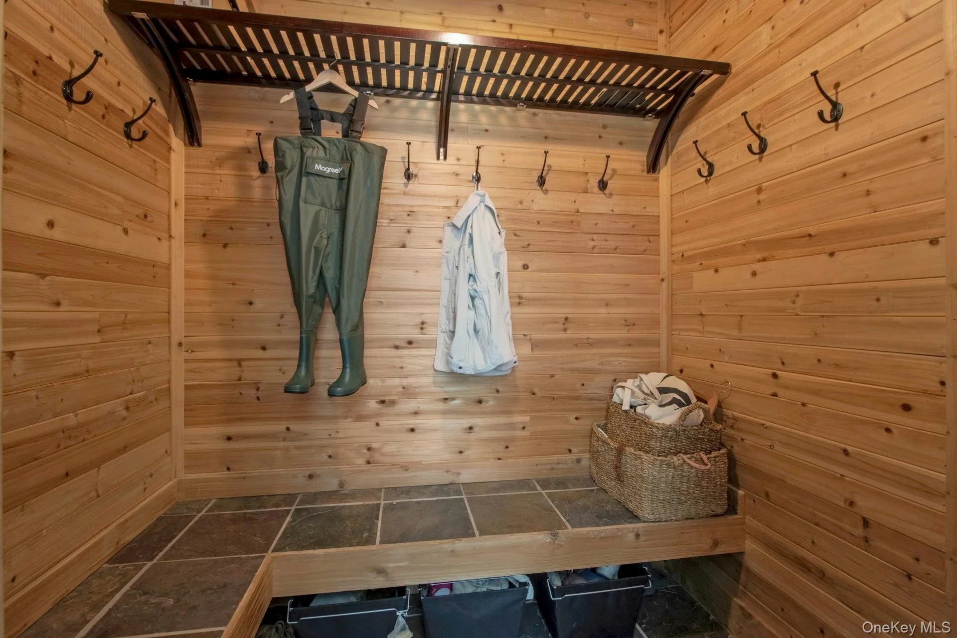 Mudroom with a sauna / steam room, wooden walls, and stone finish flooring Mudroom with a sauna / steam room, wooden walls, and stone finish flooring
