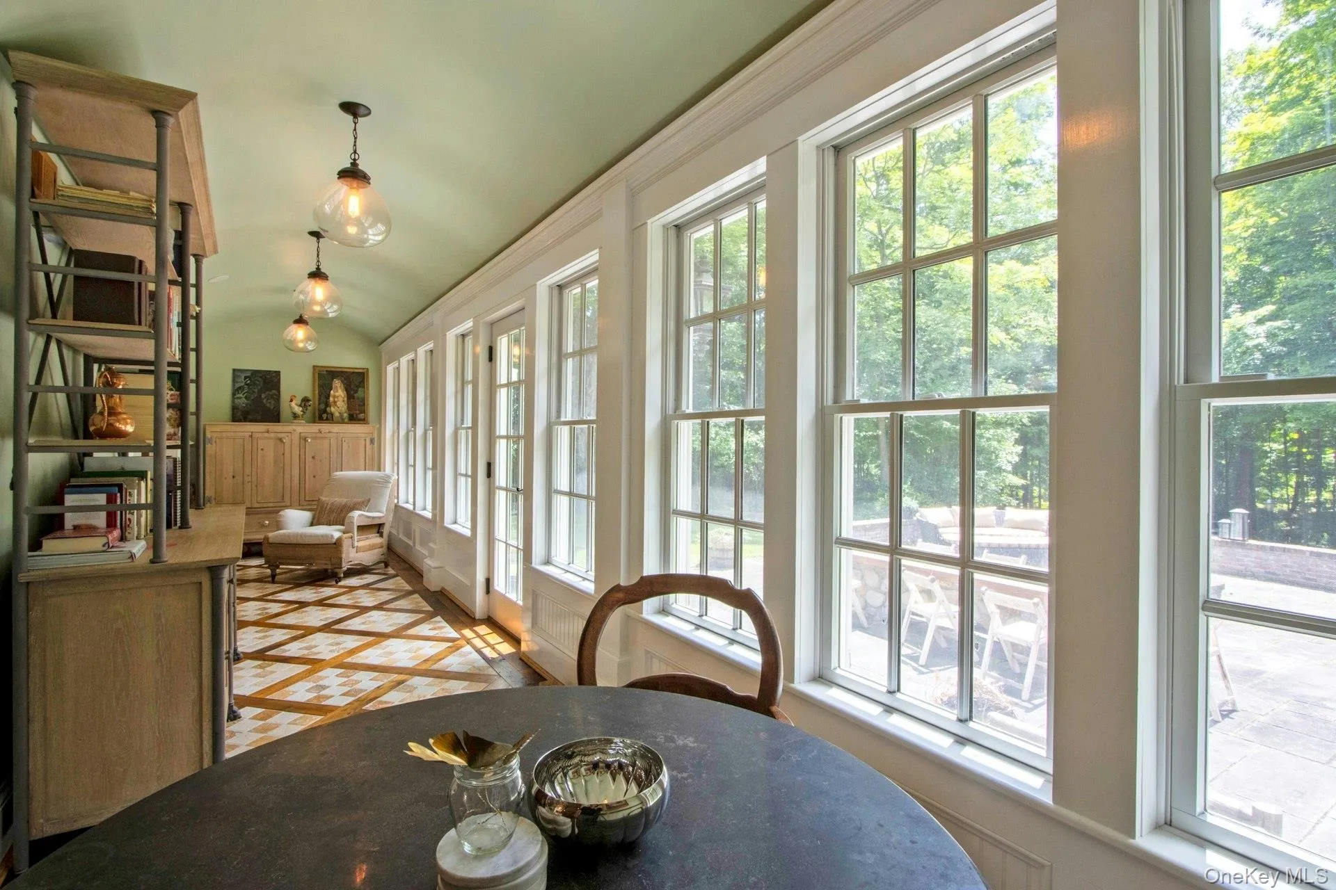 Dining space with healthy amount of natural light, vaulted ceiling, and inlaid floor details Dining space with healthy amount of natural light, vaulted ceiling, and inlaid floor details